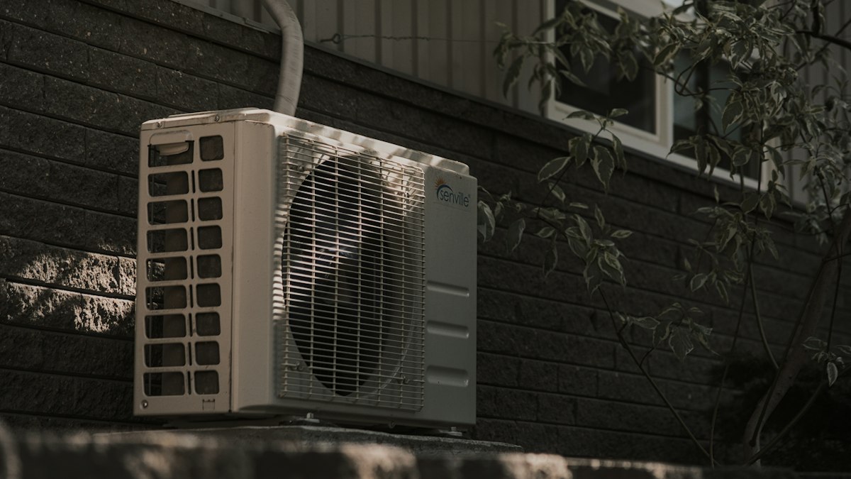 Split AC outdoor unit on a brick wall